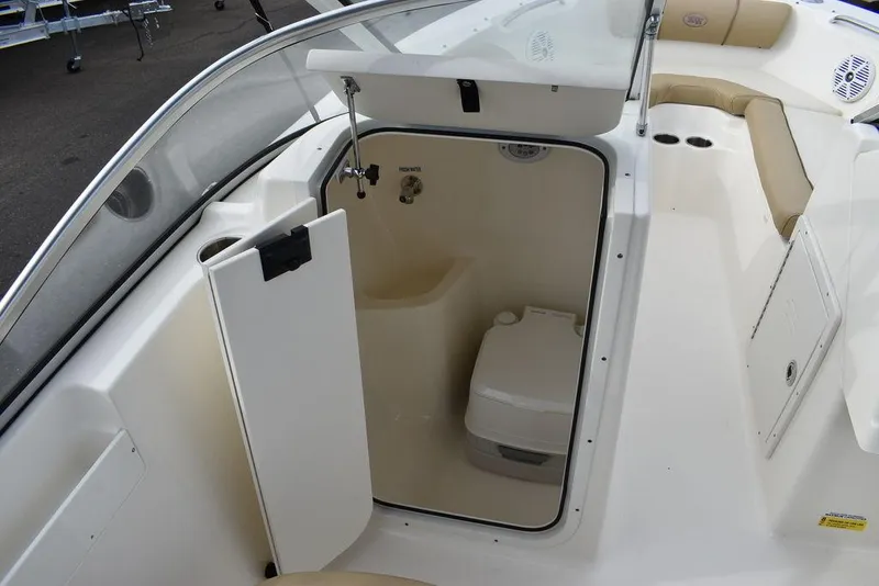 Slide: The Image of 2018 Key West 203DFS boat interior with open compartment and portable toilet. - 37