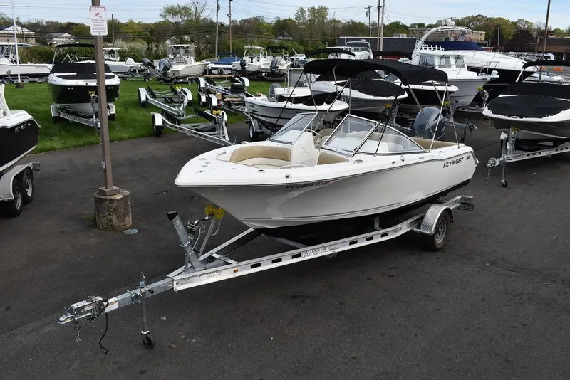 Slide: The Image of 2018 Key West 203DFS boat on a trailer in a marina. - 4