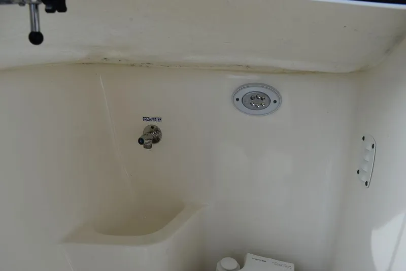 Slide: The Image of 2018 Key West 203DFS boat interior with fresh water sink and storage. - 40