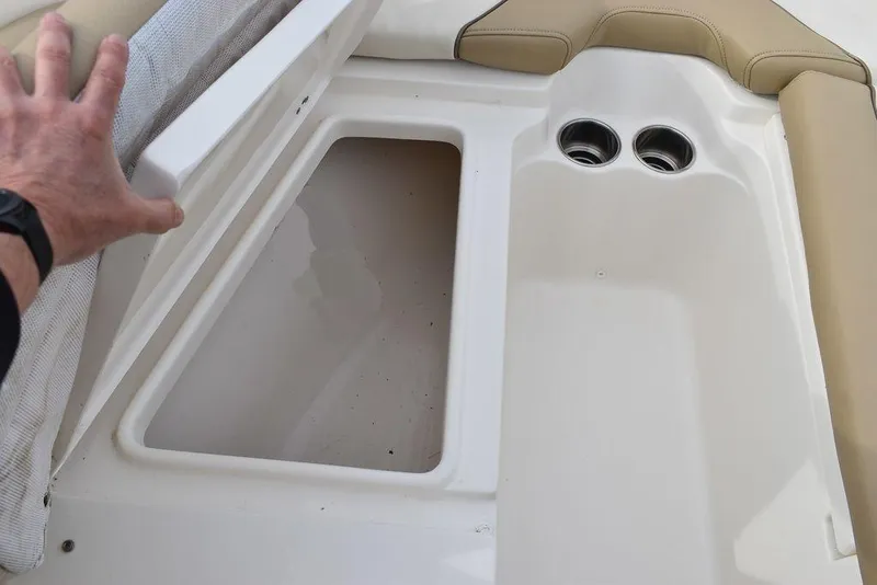 Slide: The Image of Storage compartment in a 2018 Key West 203DFS boat with cup holders. - 43