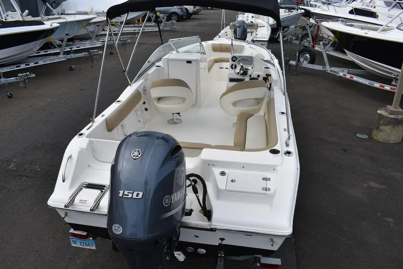 Slide: The Image of 2018 Key West 203DFS boat with Yamaha 150 engine, white interior, and seating arrangement. - 8
