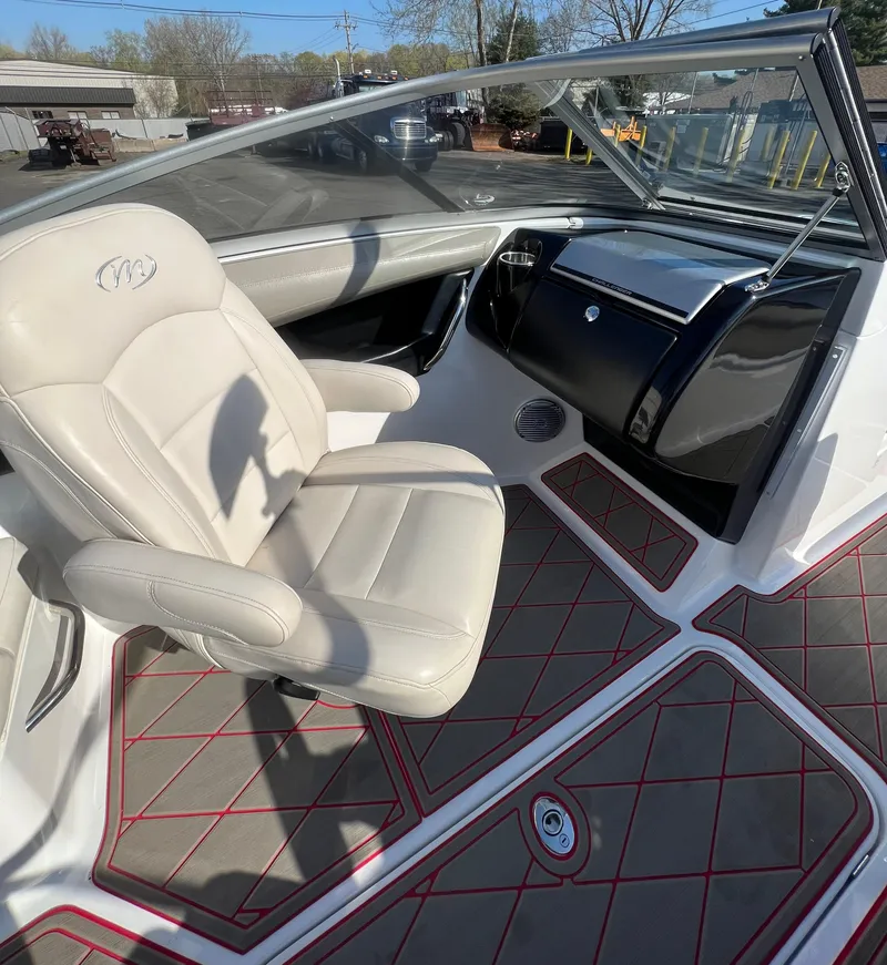 Slide: The Image of 2011 Sea-Doo 230 Wake (510 hp) boat interior with beige captain's chair and dashboard. - 14
