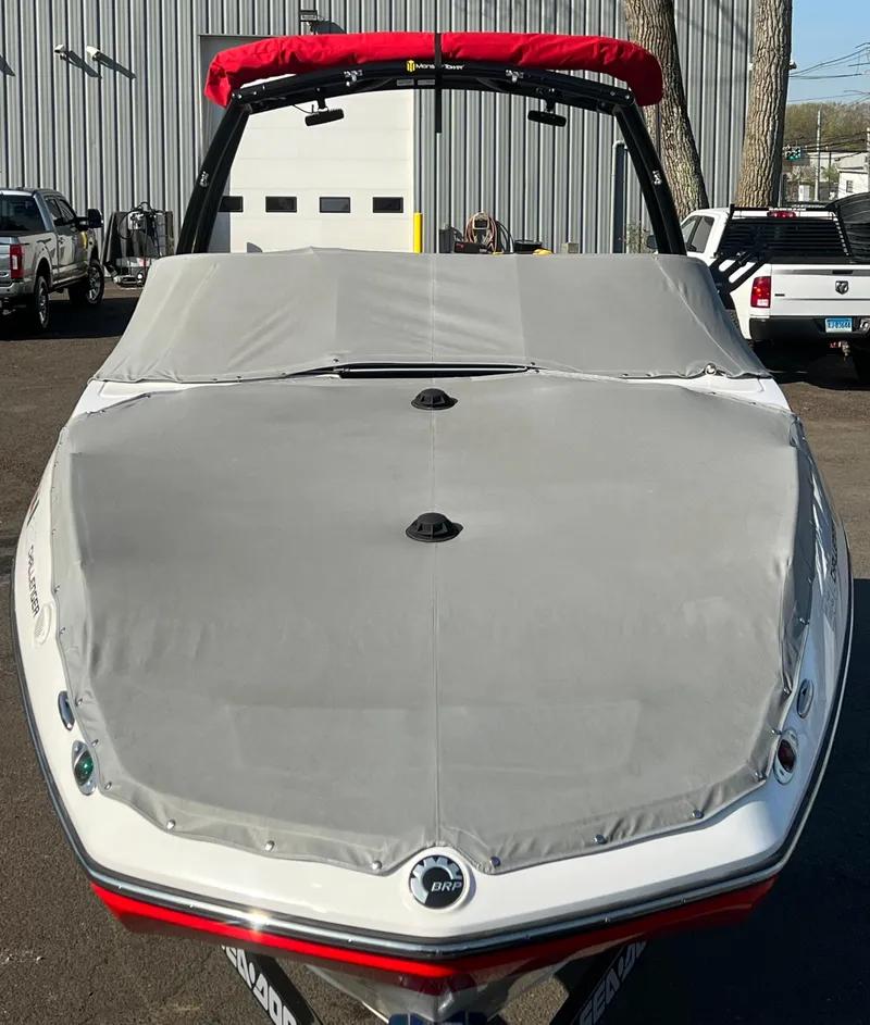 Slide: The Image of 2011 Sea-Doo 230 Wake (510 hp) boat with cover in a parking lot. - 18