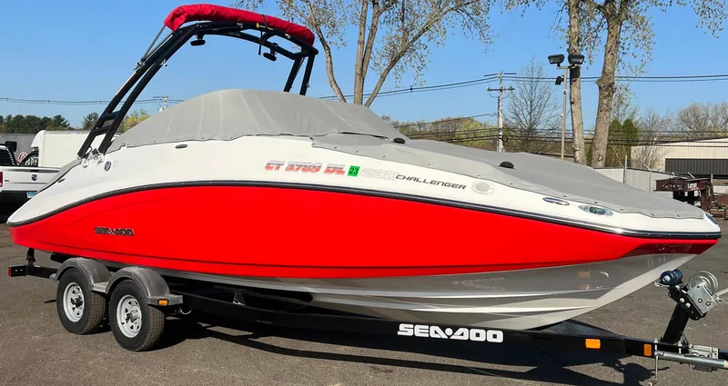 Slide: The Image of 2011 Sea-Doo 230 Wake (510 hp) boat on trailer, red and white, covered. - 19