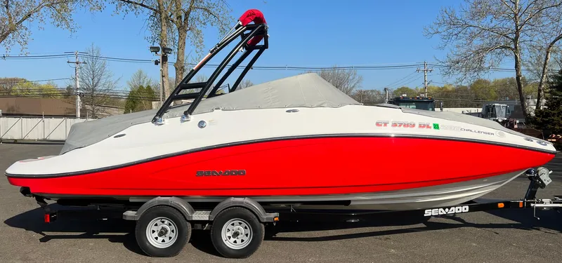 Slide: The Image of 2011 Sea-Doo 230 Wake (510 hp) boat with red and white hull on a trailer. - 20