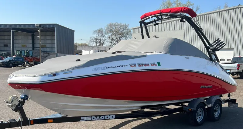 Slide: The Image of 2011 Sea-Doo 230 Wake (510 hp) boat with red hull on a trailer. - 23