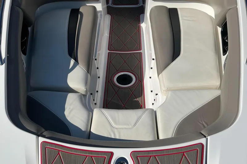 Slide: The Image of 2011 Sea-Doo 230 Wake boat interior with cushioned seating and center drain. - 25