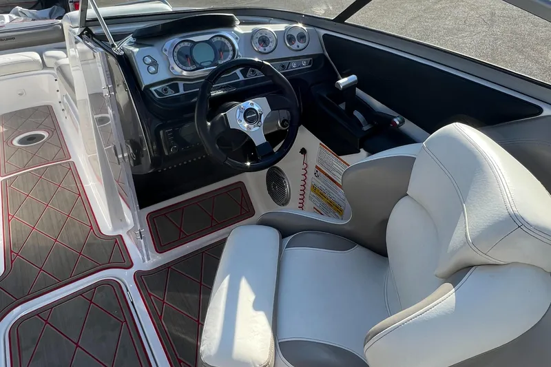 Slide: The Image of 2011 Sea-Doo 230 Wake (510 hp) boat cockpit with steering wheel and control panel. - 29