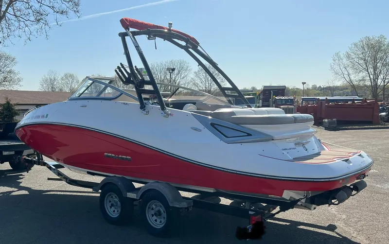 Slide: The Image of 2011 Sea-Doo 230 Wake (510 hp) boat on a trailer, red and white color scheme. - 5