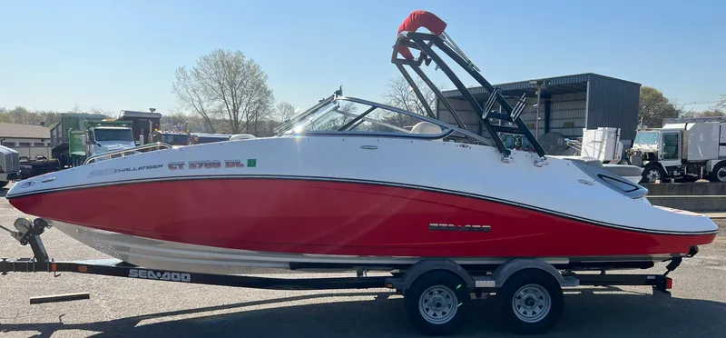 Slide: The Image of 2011 Sea-Doo 230 Wake (510 hp) boat on trailer, red and white exterior. - 6