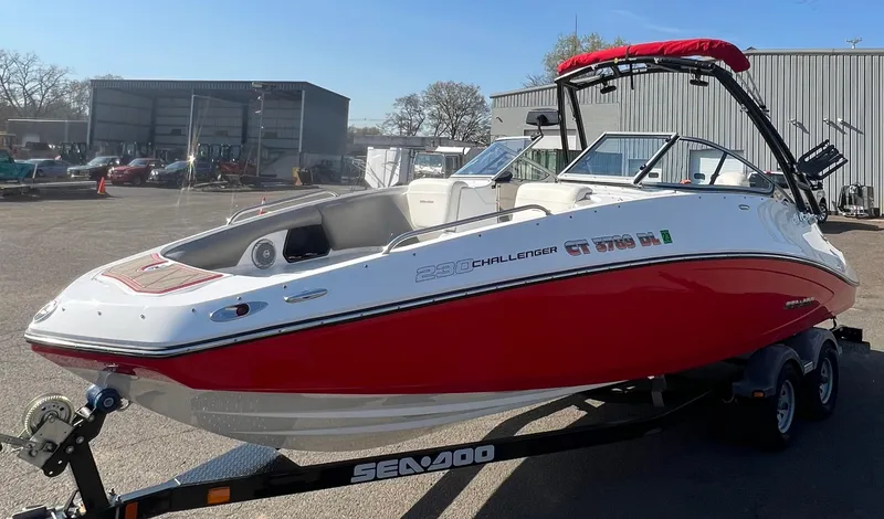 Slide: The Image of 2011 Sea-Doo 230 Wake (510 hp) boat with red and white exterior on a trailer. - 7