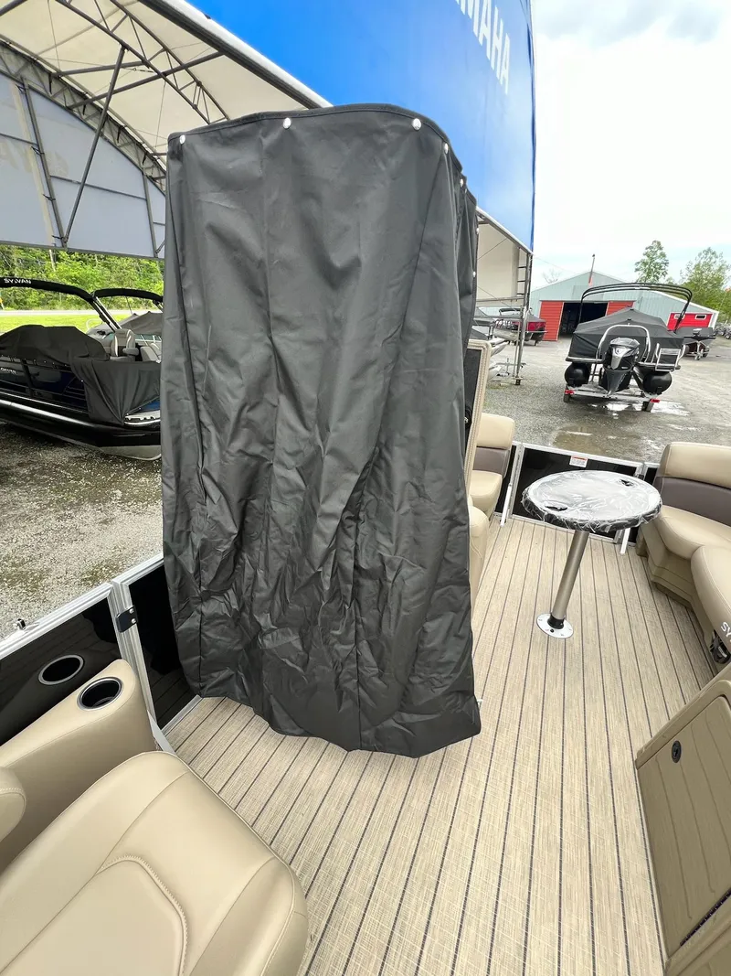 Slide: The Image of 2024 Sylvan 8522 CLZ DH Mirage pontoon boat interior with seating and table. - 10