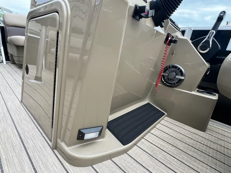 Slide: The Image of 2024 Sylvan 8522 CLZ DH Mirage boat interior, featuring control panel and seating area. - 11