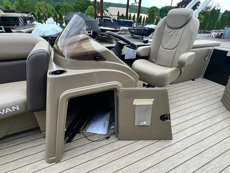 Slide: The Image of 2024 Sylvan 8522 CLZ DH Mirage boat interior with captain's chair and storage compartment. - 24