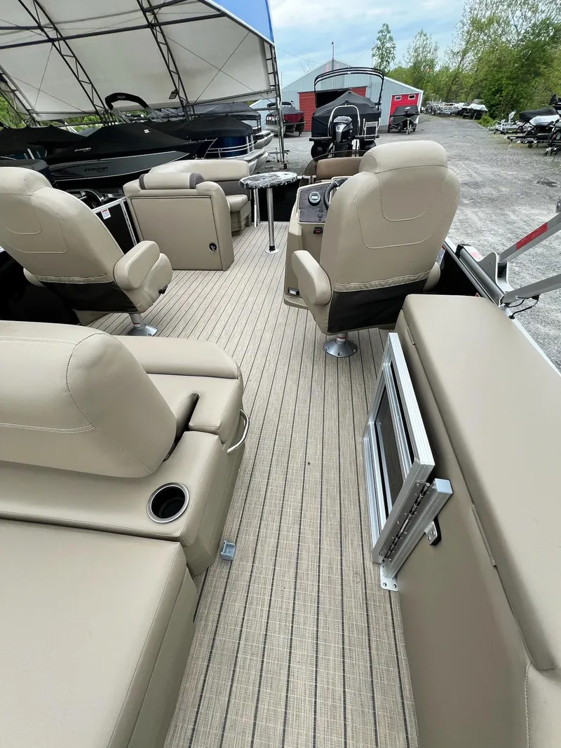 Slide: The Image of 2024 Sylvan 8522 CLZ DH Mirage pontoon boat interior with beige seating and modern amenities. - 26