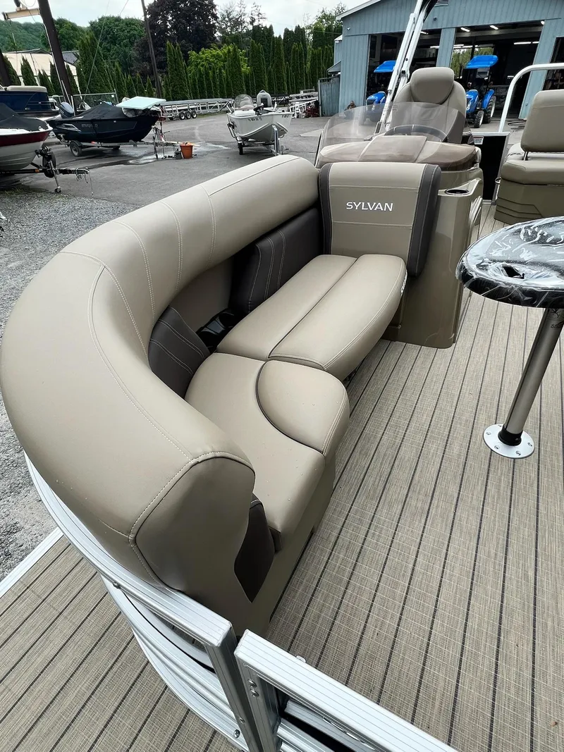 Slide: The Image of 2024 Sylvan 8522 CLZ DH Mirage pontoon boat with beige seating and striped flooring. - 28