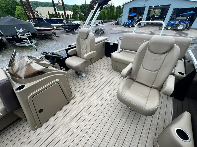 Slide: The Image of 2024 Sylvan 8522 CLZ DH Mirage pontoon boat interior with beige seating and helm. - 32