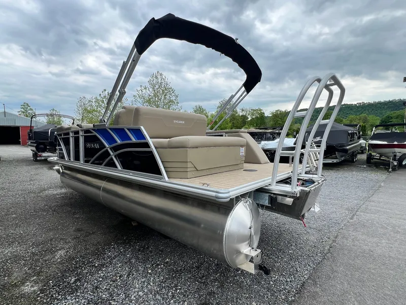 Slide: The Image of 2024 Sylvan 8522 CLZ DH Mirage pontoon boat with canopy, docked outdoors. - 33