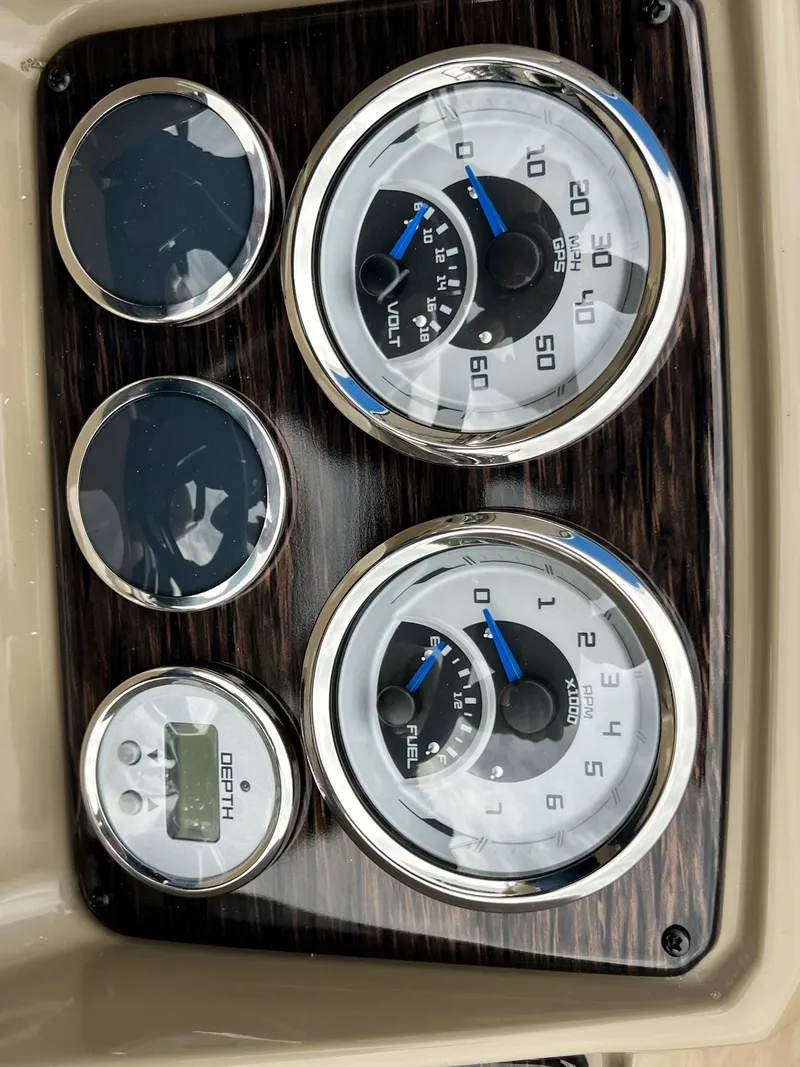 Slide: The Image of Dashboard gauges of 2024 Sylvan 8522 CLZ DH Mirage boat, including speedometer, fuel gauge, and depth meter. - 34