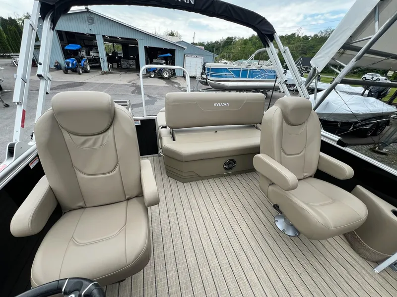 Slide: The Image of 2024 Sylvan 8522 CLZ DH Mirage pontoon boat interior with beige seating. - 36
