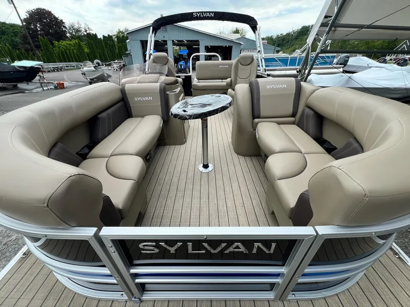 Slide: The Image of 2024 Sylvan 8522 CLZ DH Mirage pontoon boat with beige seating and table. - 38