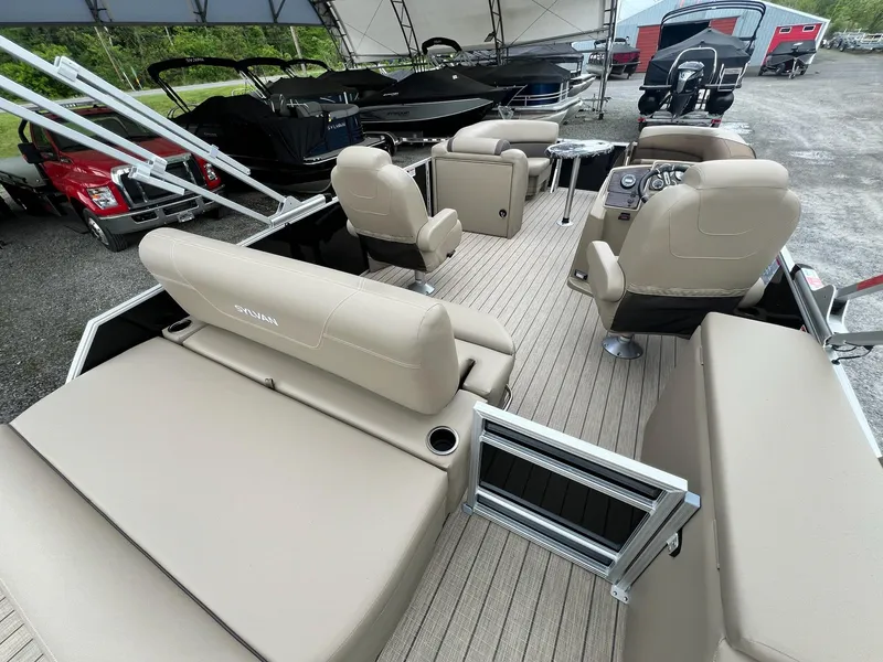 Slide: The Image of 2024 Sylvan 8522 CLZ DH Mirage pontoon boat interior with beige seating and modern helm. - 39