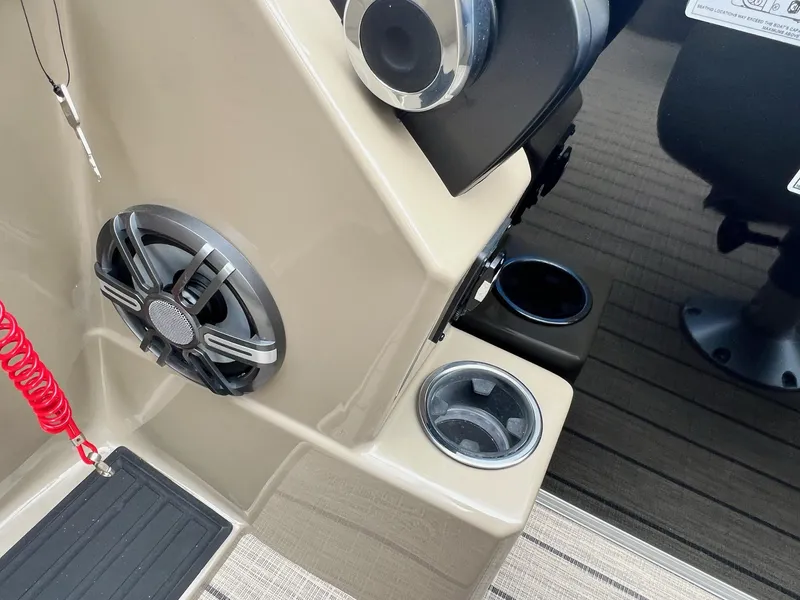 Slide: The Image of Close-up of the 2024 Sylvan 8522 CLZ DH Mirage boat's control panel with speaker and cup holders. - 4