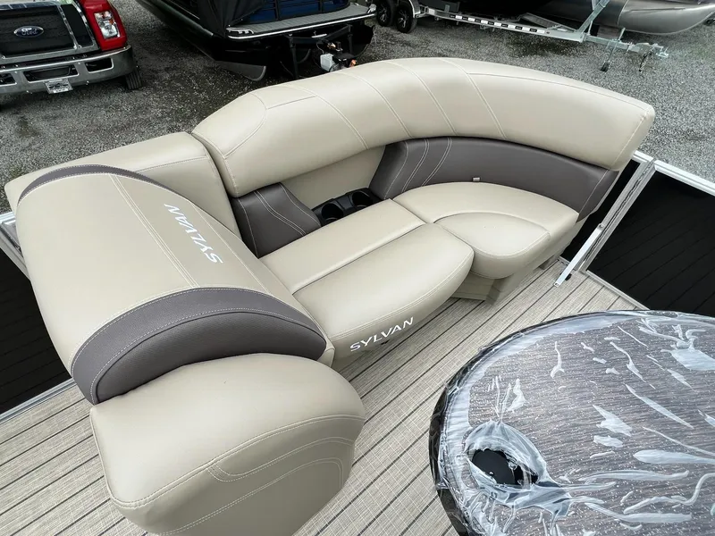 Slide: The Image of 2024 Sylvan 8522 CLZ DH Mirage boat with beige and gray seating. - 42