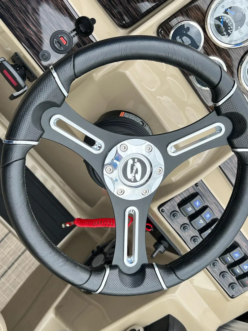 Slide: The Image of Steering wheel and dashboard of 2024 Sylvan 8522 CLZ DH Mirage boat. - 44