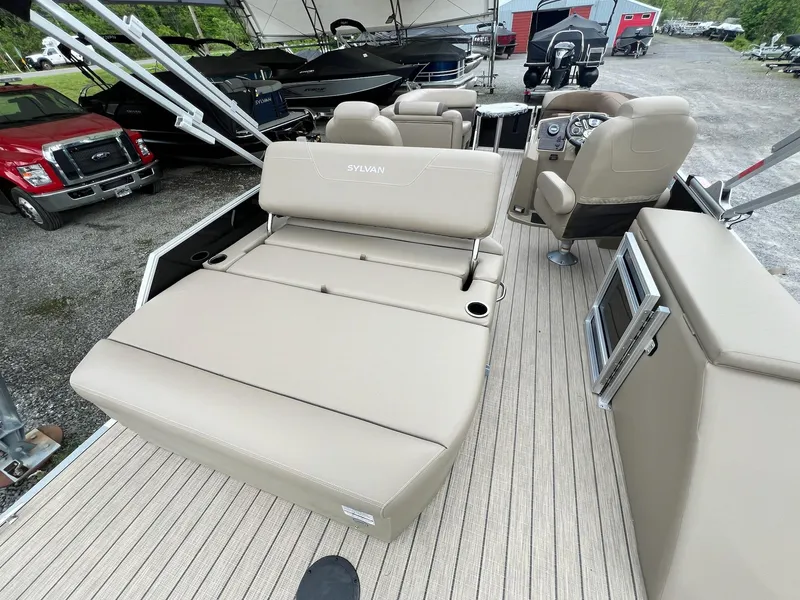 Slide: The Image of 2024 Sylvan 8522 CLZ DH Mirage pontoon boat interior with beige seating and modern dashboard. - 45