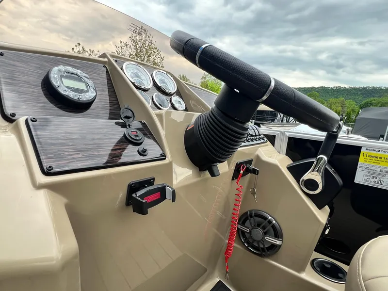 Slide: The Image of 2024 Sylvan 8522 CLZ DH Mirage boat dashboard with steering wheel and control panel. - 6