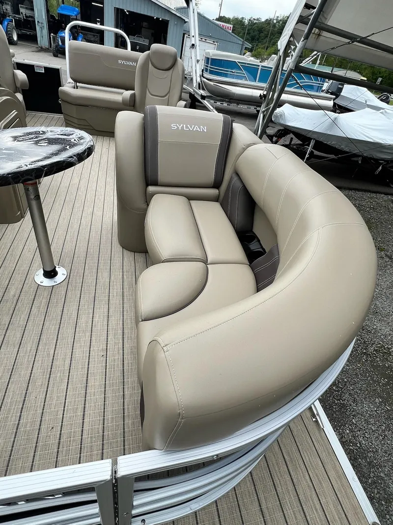 Slide: The Image of 2024 Sylvan 8522 CLZ DH Mirage pontoon boat with beige seating and table. - 7