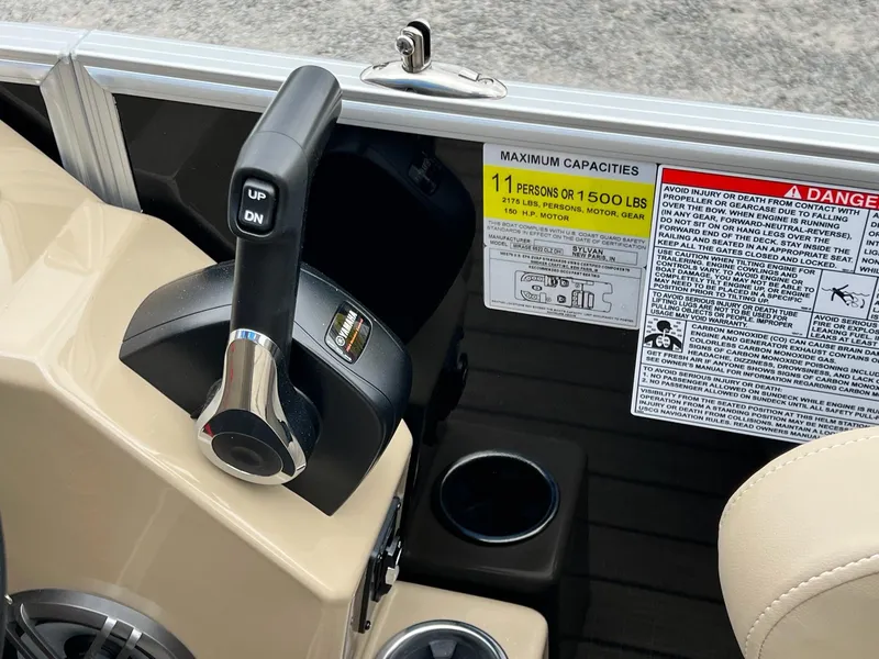Slide: The Image of Close-up of the control panel and capacity label on a 2024 Sylvan 8522 CLZ DH Mirage boat. - 8