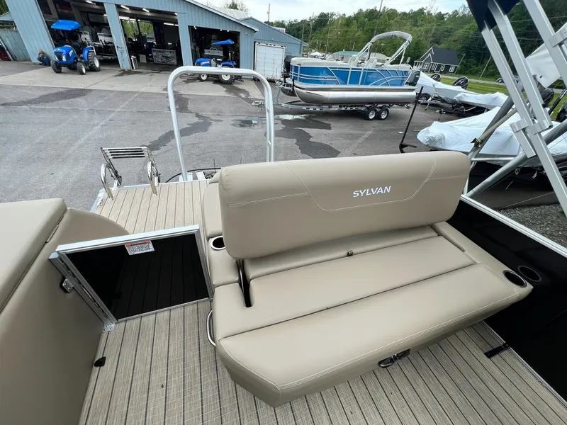 Slide: The Image of 2024 Sylvan 8522 CLZ DH Mirage pontoon boat with beige seating and rear deck. - 9