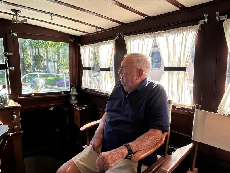 Slide: The Image of Elderly man sitting inside a 1930 Classic ACF 47' Motor Yacht. - 48
