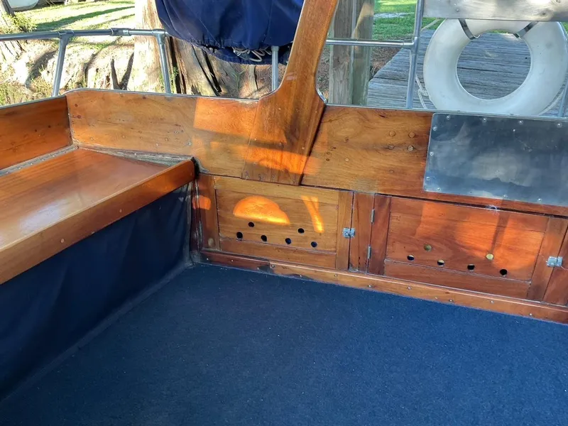Slide: The Image of Interior of a 1930 Classic ACF 47' Motor Yacht with wooden seating and storage. - 12