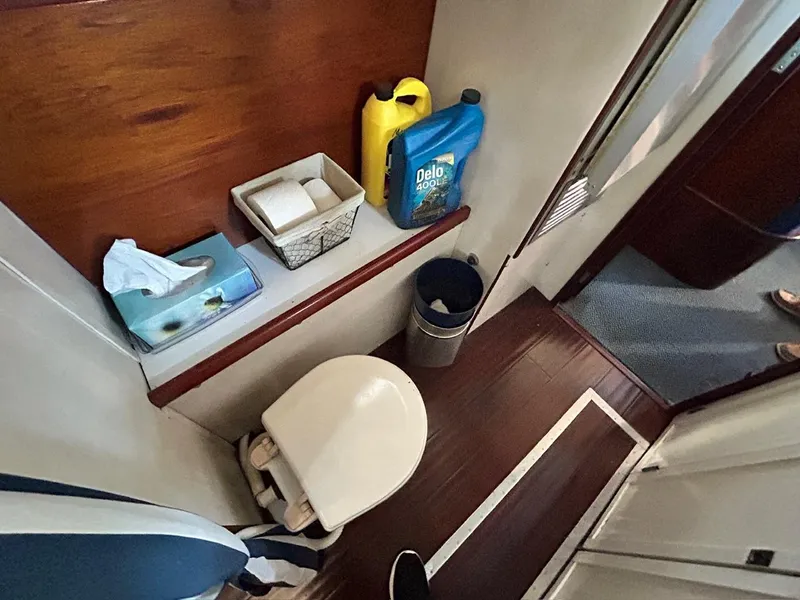 Slide: The Image of Classic 1930 ACF 47' Motor Yacht bathroom with toilet, tissue, and cleaning supplies. - 32