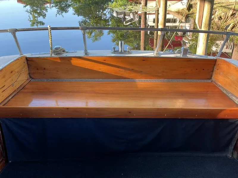 Slide: The Image of Classic 1930 ACF 47' Motor Yacht with polished wooden bench and serene water reflection. - 9