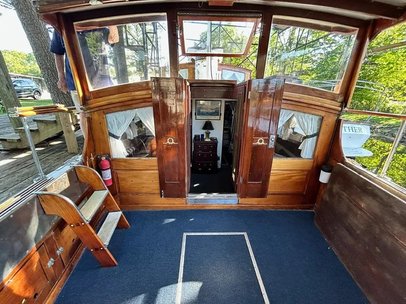 Slide: The Image of Interior of a 1930 Classic ACF 47' Motor Yacht with wooden finishes and blue carpet. - 3