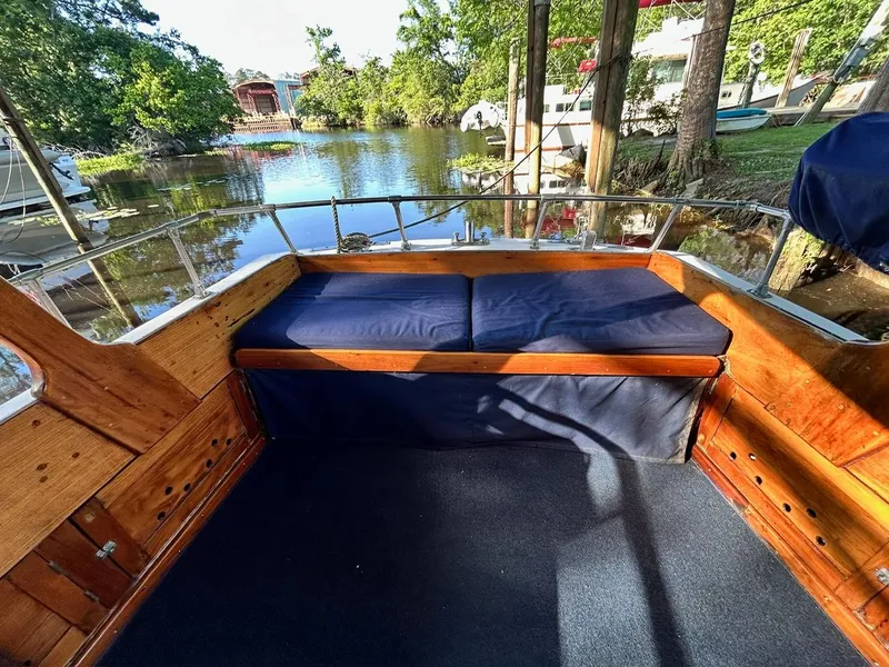Slide: The Image of Classic 1930 ACF 47' Motor Yacht with wooden interior and cushioned seating by a serene lake. - 7