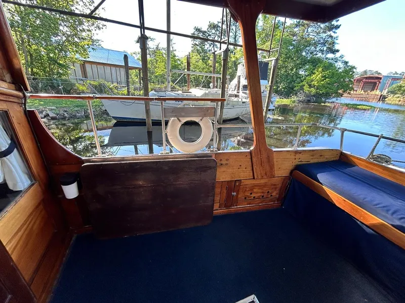 Slide: The Image of Interior view of 1930 Classic ACF 47' Motor Yacht with wooden details and waterfront scenery. - 13