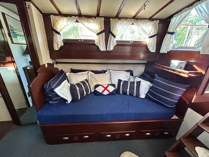 Slide: The Image of Interior of 1930 Classic ACF 47' Motor Yacht with cozy seating and nautical-themed pillows. - 24