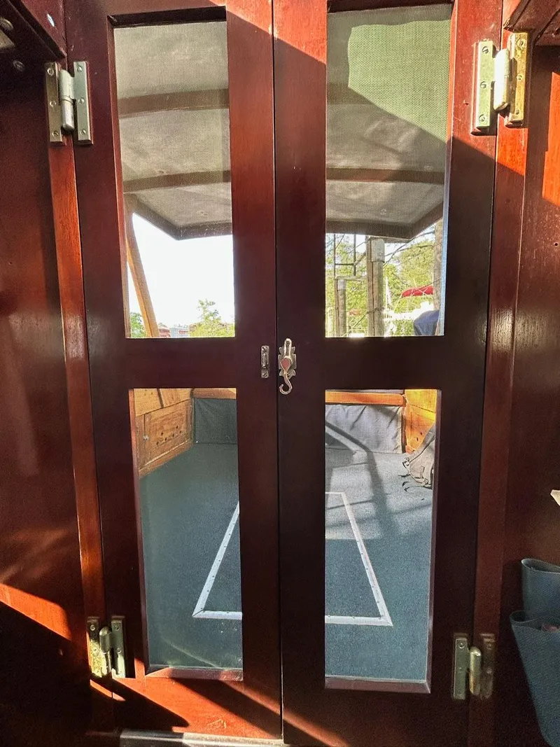 Slide: The Image of Interior view of 1930 Classic ACF 47' Motor Yacht with wooden doors and glass panels. - 5