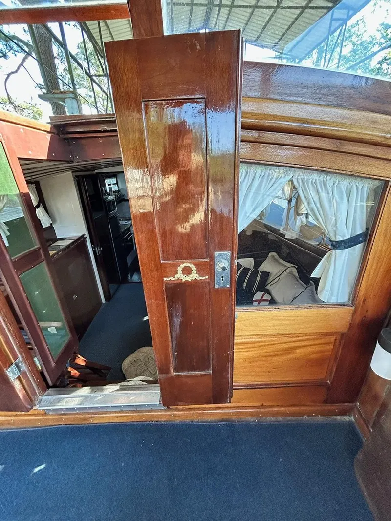 Slide: The Image of 1930 Classic ACF 47' Motor Yacht interior with wooden door and cozy cabin. - 11
