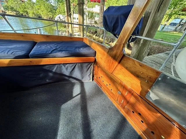 Slide: The Image of Interior of 1930 Classic ACF 47' Motor Yacht with wooden seating and blue cushions. - 15