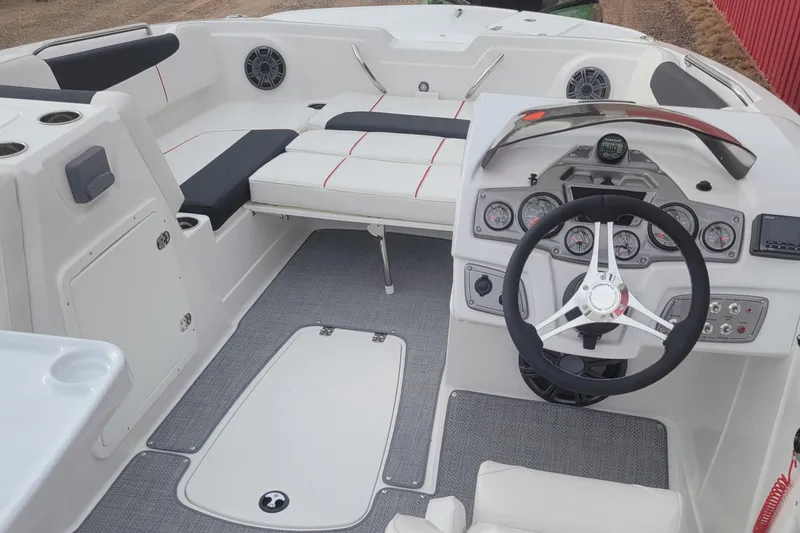 Slide: The Image of Interior of a 2023 Tahoe 1950 boat featuring steering wheel and seating area. - 2