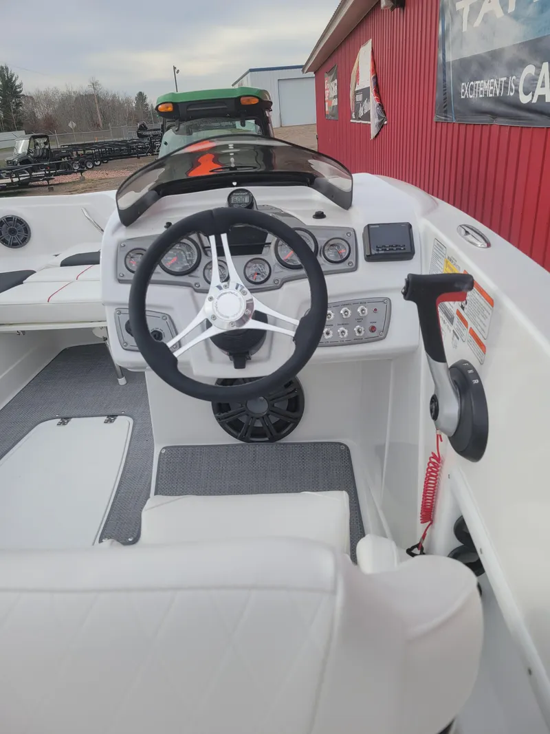 Slide: The Image of Interior of a 2023 Tahoe 1950 boat showing steering wheel and dashboard controls. - 3