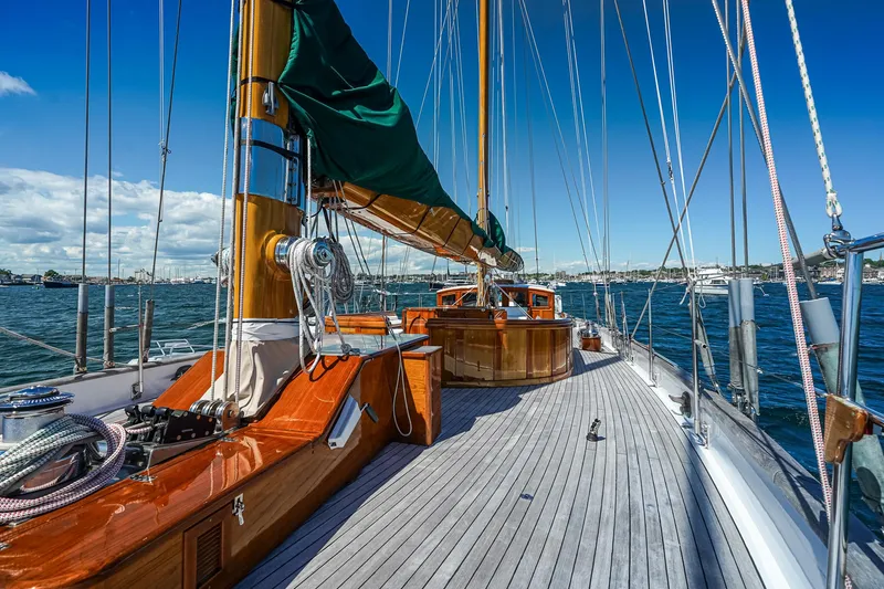 Slide: The Image of 1929 Lyman-Morse Staysail Schooner on open water, showcasing wooden deck and rigging. - 11