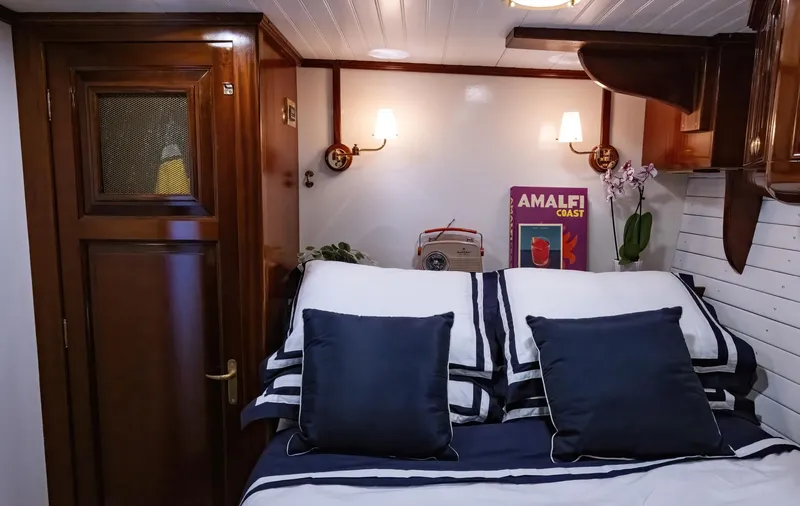 Slide: The Image of Cozy cabin interior of 1929 Lyman-Morse Staysail Schooner with bed and vintage decor. - 40