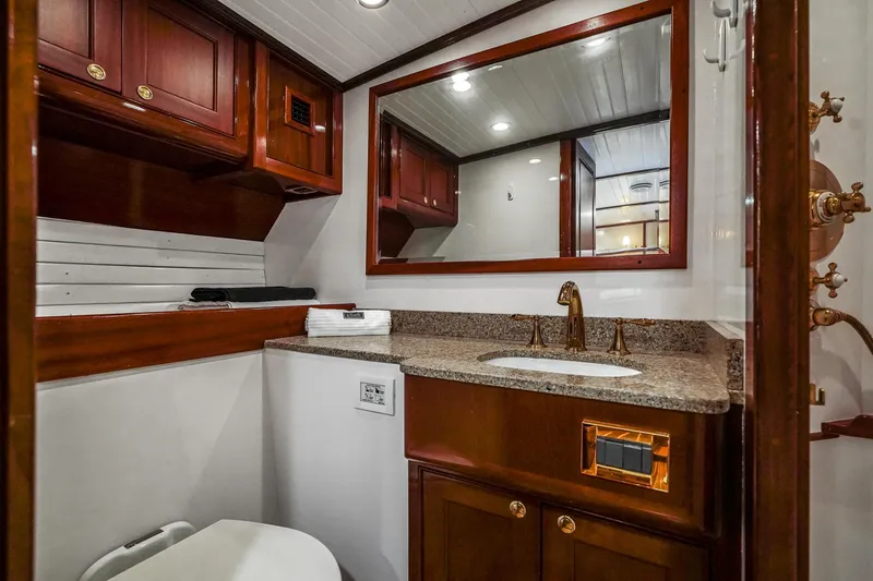 Slide: The Image of Luxurious 1929 Lyman-Morse Staysail Schooner bathroom with wood cabinetry and granite countertop. - 41